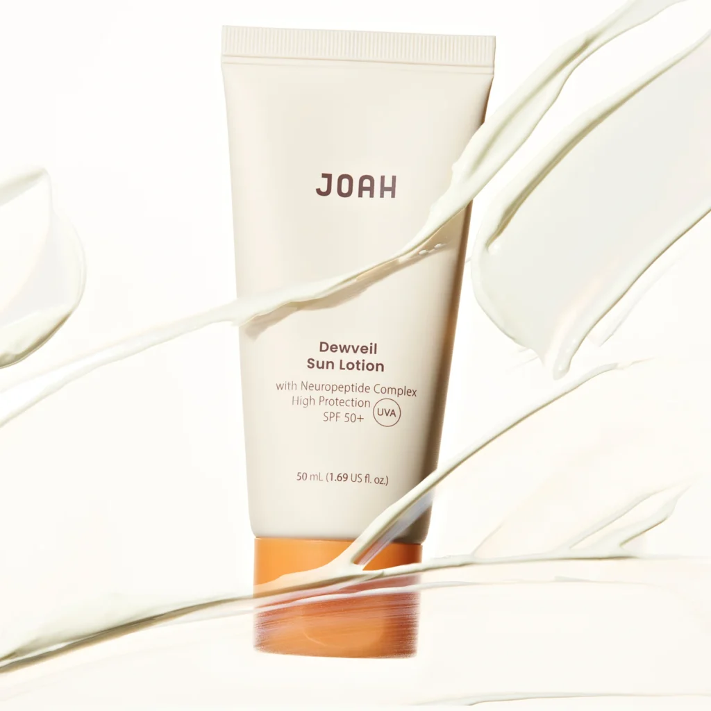 JOAH DewVeil SPF50 Sun Lotion 50ml surrounded by swatches of sunscreen